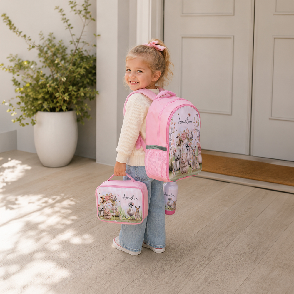 Child wearing personalised school backpack with matching lunch bag and drink bottle