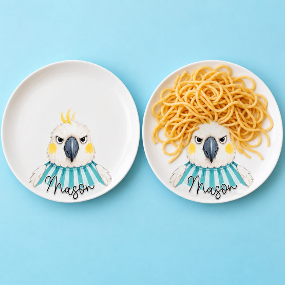 Two cockatoo plates personalised with the name Mason, one empty and the other with spaghetti arranged as hair.